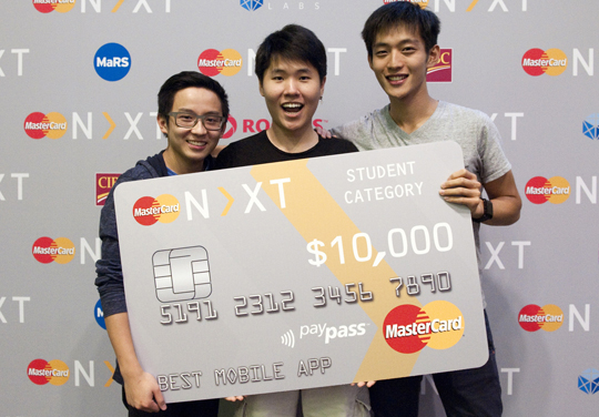 Team PayMint accepts the $10,000 prize for their win in the student competition of MasterCard's N>XT hackathon.