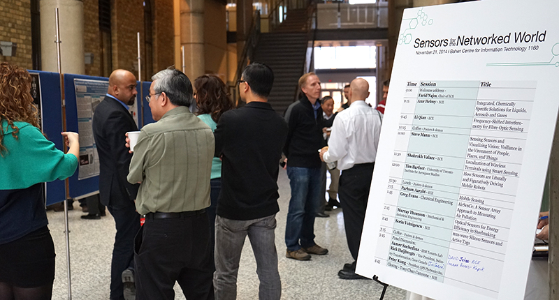 Attendees network and discuss posters presented at Sensors for the Networked World, November 21, 2014.