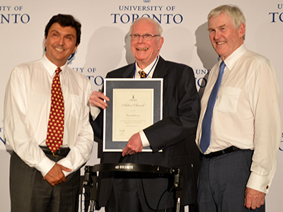 Warren Brown receives his Arbor Award from University of Toronto President David Naylor and Chancellor Michael Wilson.