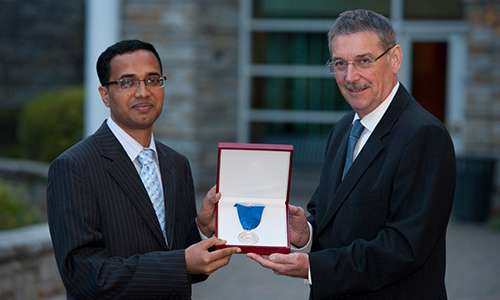 Dr. Muhammad K. Alam receives the 2013 Douglas R. Colton Medal for Research Excellence from Dr. Ian L. McWalter, President and CEO of CMC Microsystems. (Image Credit: Mark Holleron)