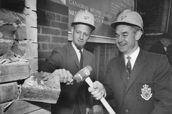 
James Milton Ham (ElecE 4T3) (left) and R.F. Moore (BASc MinE 4T5) at the ceremony for the demolition of the School of Practical Science, 1966 (Photo: University of Toronto Archives). 

