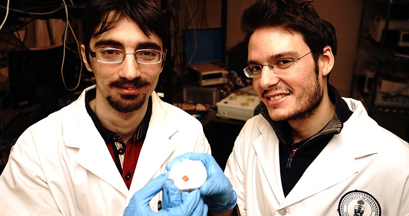 Researchers Valerio Adinolfi (left) and Riccardo Comin examine a perovskite crystal. Perovskites are attracting growing interest in the context of thin-film solar technologies, but had never been studied in their purest form: as perfect single crystals.