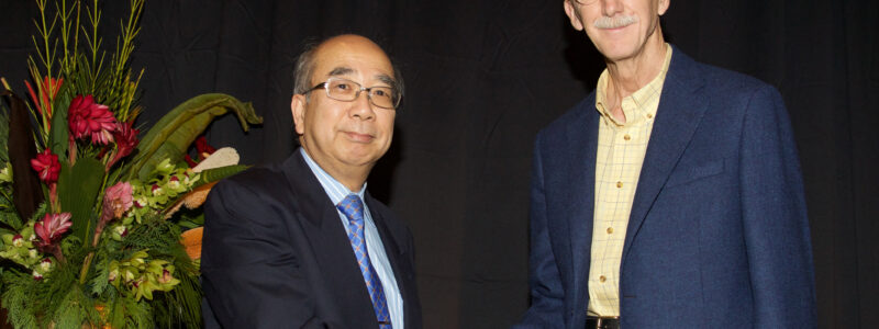 Professor Yutaka Yamamoto, former president of the IEEE Control Systems Society, congratulates Professor Francis.