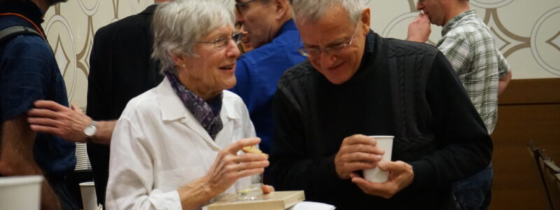 Dr. Anne Wonham shares a snack and a laugh with Professor Peter Caines, of McGill University.