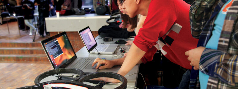 ECE student Junqian Zhang and his team coded their own gesture-control program to race drones in a recent aerial robotics competition. (Credit: Roberta Baker)