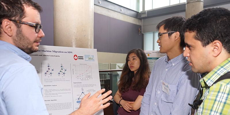Pouya Yasrebi presents his work to fellow attendees during the first poster and demonstration sessions on July 7, 2015.