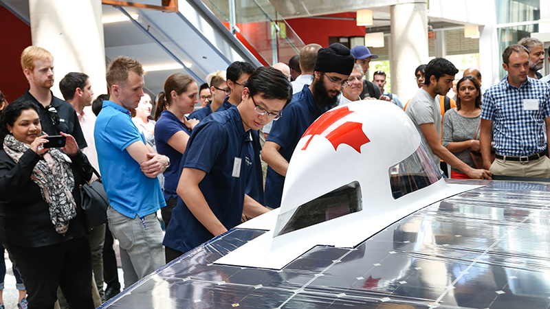 Attendees flock to see the newly revealed Horizon, the Blue Sky Solar Racing Team's eighth-generation solar vehicle.