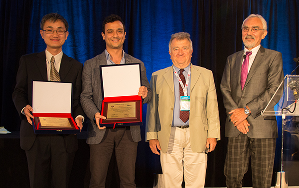 (left to right): Wei Yu, Onur Sahin (two of the five co-authors of the paper), Anthony Ephremides (Editor-in-Chief of JCN), and Lajos Hanzo (Chair of the Awards Committee of the IEEE Communications Society). 