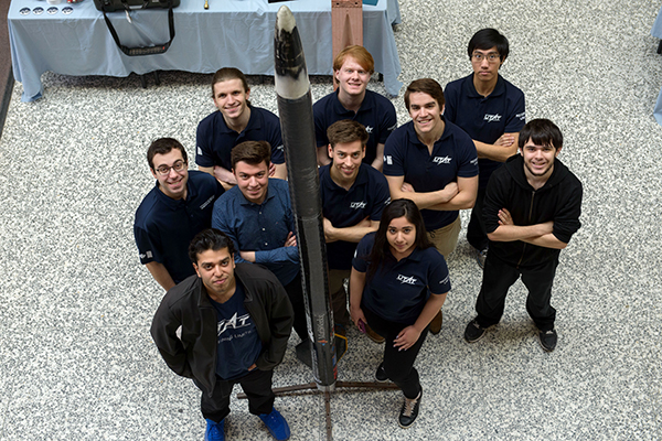 Members of the UTAT Rocketry Division with their rocket