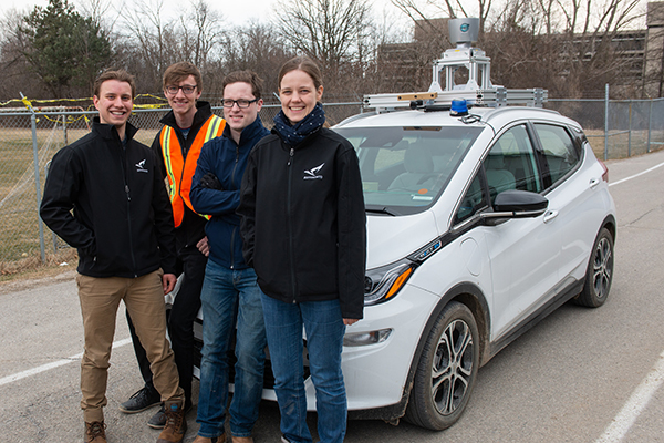 aUToronto team members in front of their autonomous vehicle, Zeus.