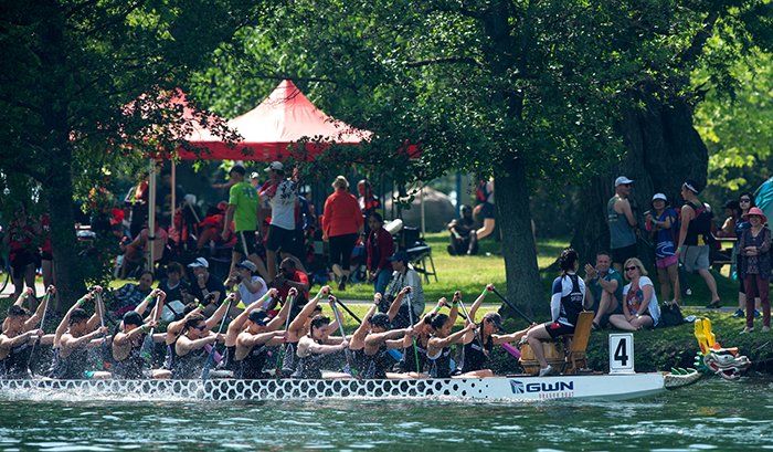 Iron Dragons boat cruises by onlookers