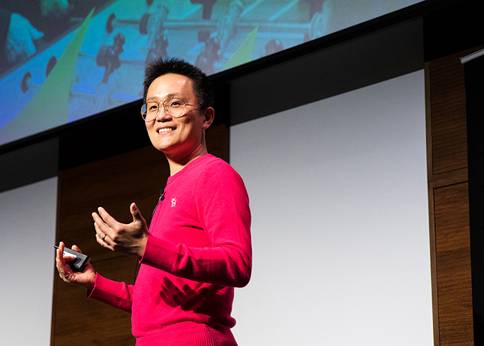 Allen Lau in front of a screen