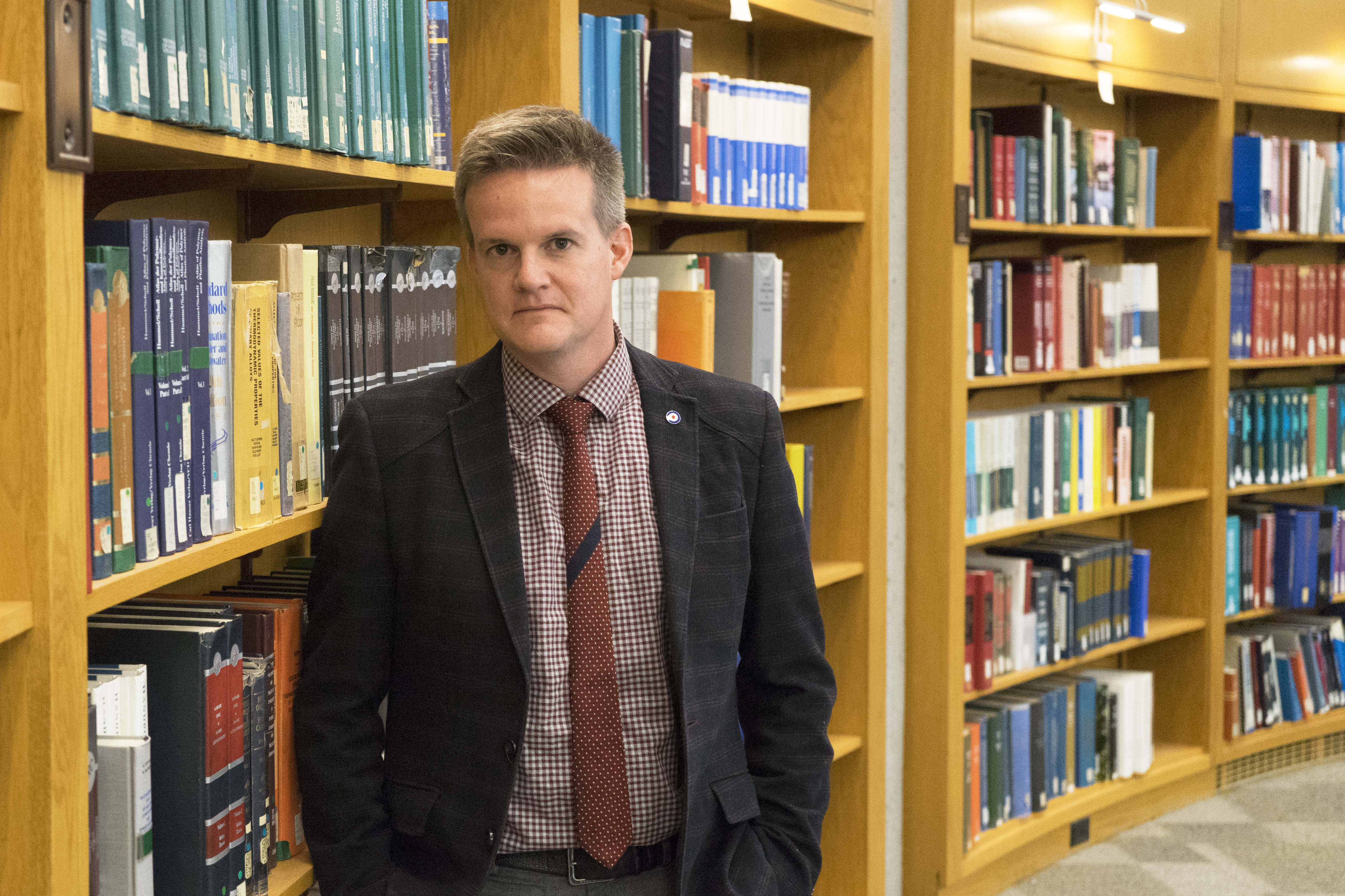 Professor Jason Anderson stands in the Engineering Library at U of T