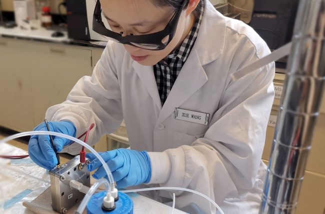 U of T Engineering postdoctoral fellow Xue Wang installs a membrane electrode assembly cell for testing the performance of a catalyst. Made by coating copper with a layer of carbon-doped nitrogen, the catalyst is designed to efficiently convert CO2 into ethanol. (Photo courtesy Xue Wang)