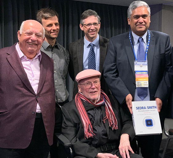 The 8th edition of Microelectronic Circuits, known worldwide as “Sedra/Smith,” was published in late 2019. Celebrating the launch in February 2020 are (from l to r) Professors Adel Sedra, Tony Chan Carusone (both ECE) and Vincent Gaudet (U Waterloo), along with Professors K.C. Smith (ECE, seated) and Anantha Chandrakasan (M.I.T. and ISSCC 2020 Sr. Technical Advisor). (Photo by Danny Zhang (ECE MASc candidate))