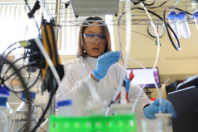 PhD candidate Geonhui Lee works on an electrolyzer in the lab of Professor Ted Sargent (ECE). She is the lead author on a new paper in Nature Energy that outlines an electrochemical method for converting captured carbon into useful products, from fuels to plastics. (Photo: Marit Mitchell)