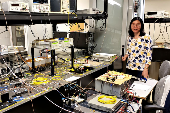 Professor Li Qian (ECE), shown in her lab pre-pandemic, is part of a research team that proposed a new quantum fingerprinting protocol, which is used to quickly and securely identify whether information from two sources is the same. (Photo: Don Figer)