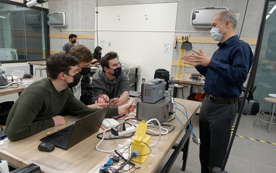 (from left to right) Adam McDonald, Damian Pacynko and Andrew Moser (all Year 2 ElecE) and Professor Sean Hum