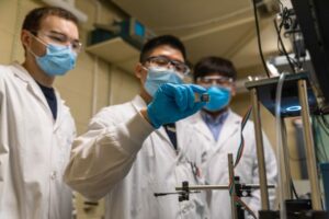 Research team in lab showing prototype