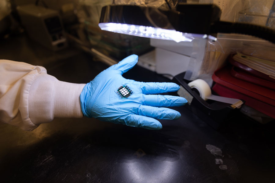 Small prototype on palm of researcher's gloved hand