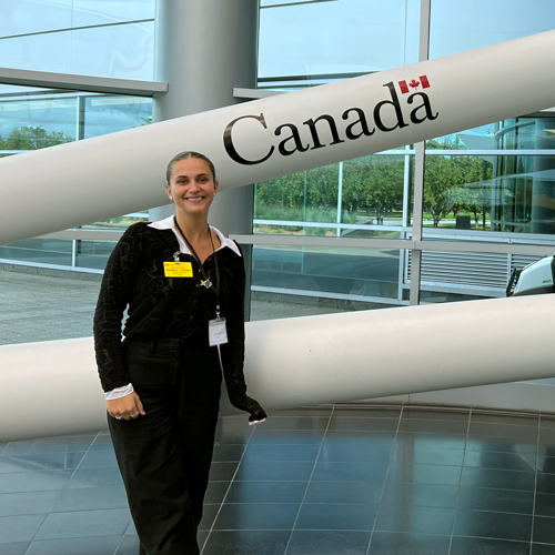 Undergrad Anaïs Poirier in lobby in front of Canadarm
