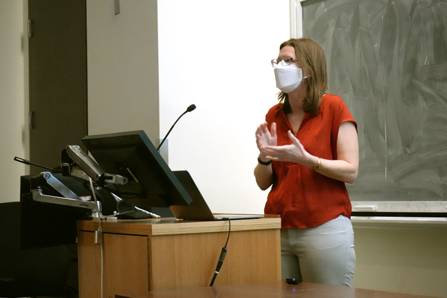 Professor behind lectern and in front of chalkboard