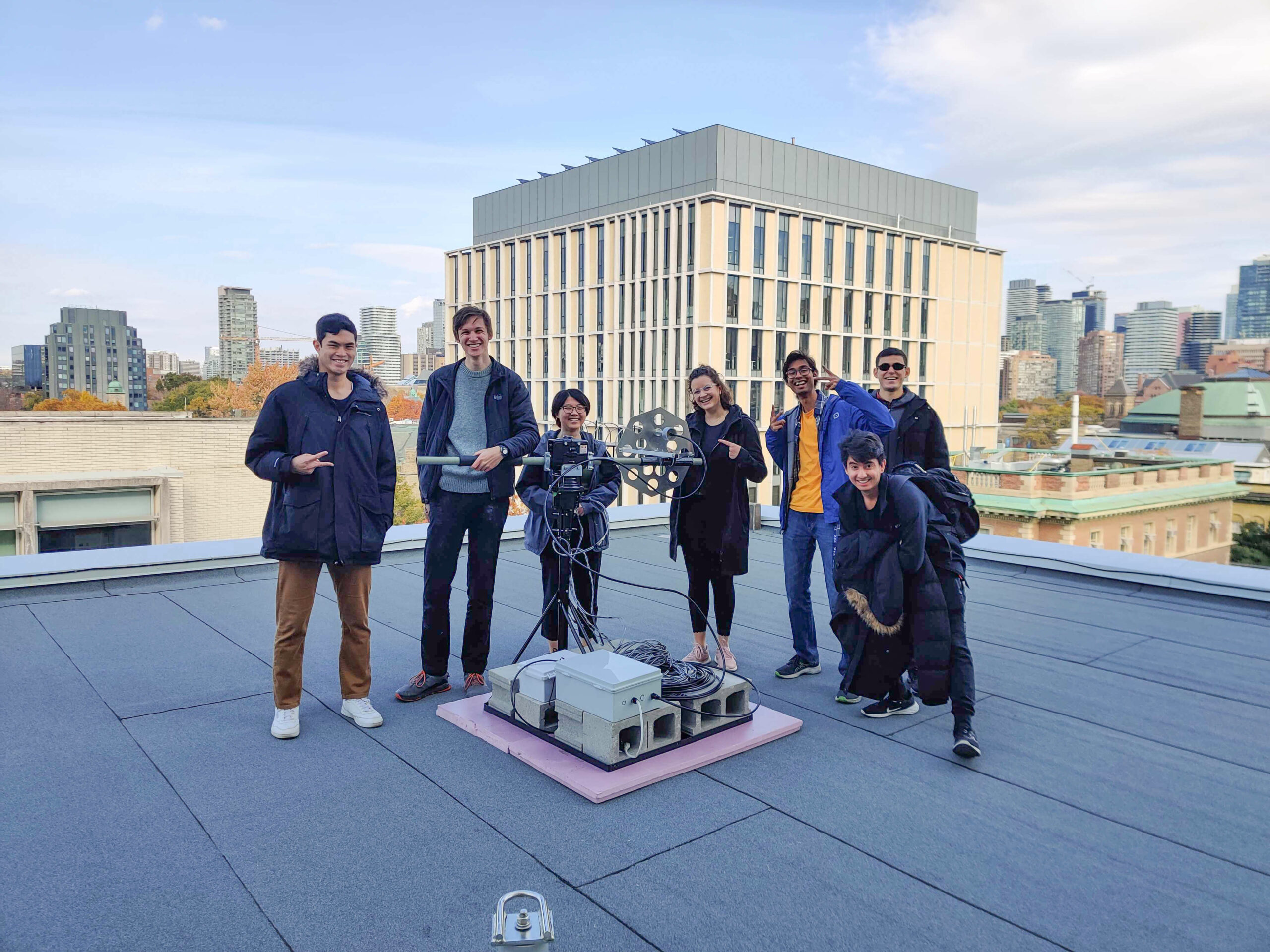 Teams members assembled on the roof around equipment on clear day