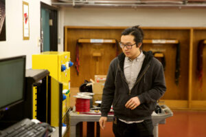 Teacher standing before equipment, explaining components