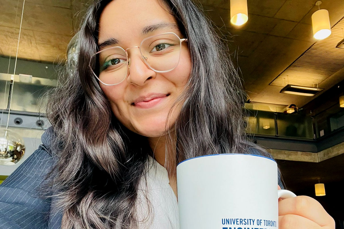 Smiling student with University of Toronto mug.