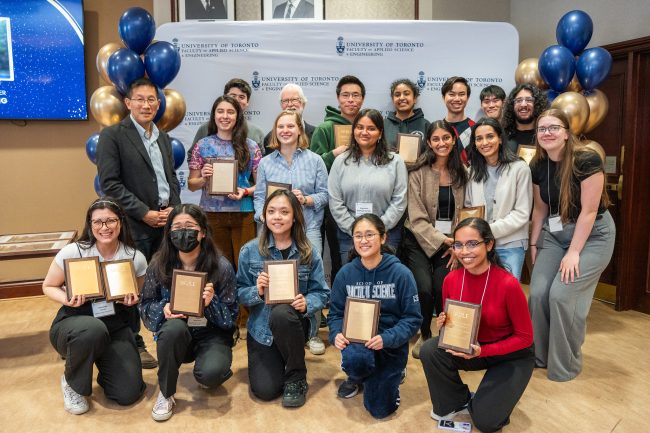 Students gathered around displaying certificates